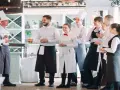 L'équipe d'un restaurant en uniforme, discutant de la gestion du personnel.