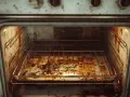 Intérieur d'un four très sale, plein de graisses et de résidus. Idéal pour apprendre comment nettoyer un four avec du vinaigre blanc.
