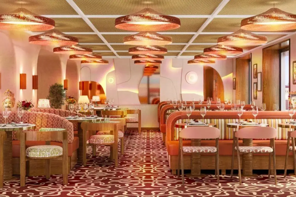 Ambiance chaleureuse pour une id&eacute;e soir&eacute;e &agrave; th&egrave;me restaurant. D&eacute;coration audacieuse avec tapis rouge, banquettes orange et suspensions cuivr&eacute;es.